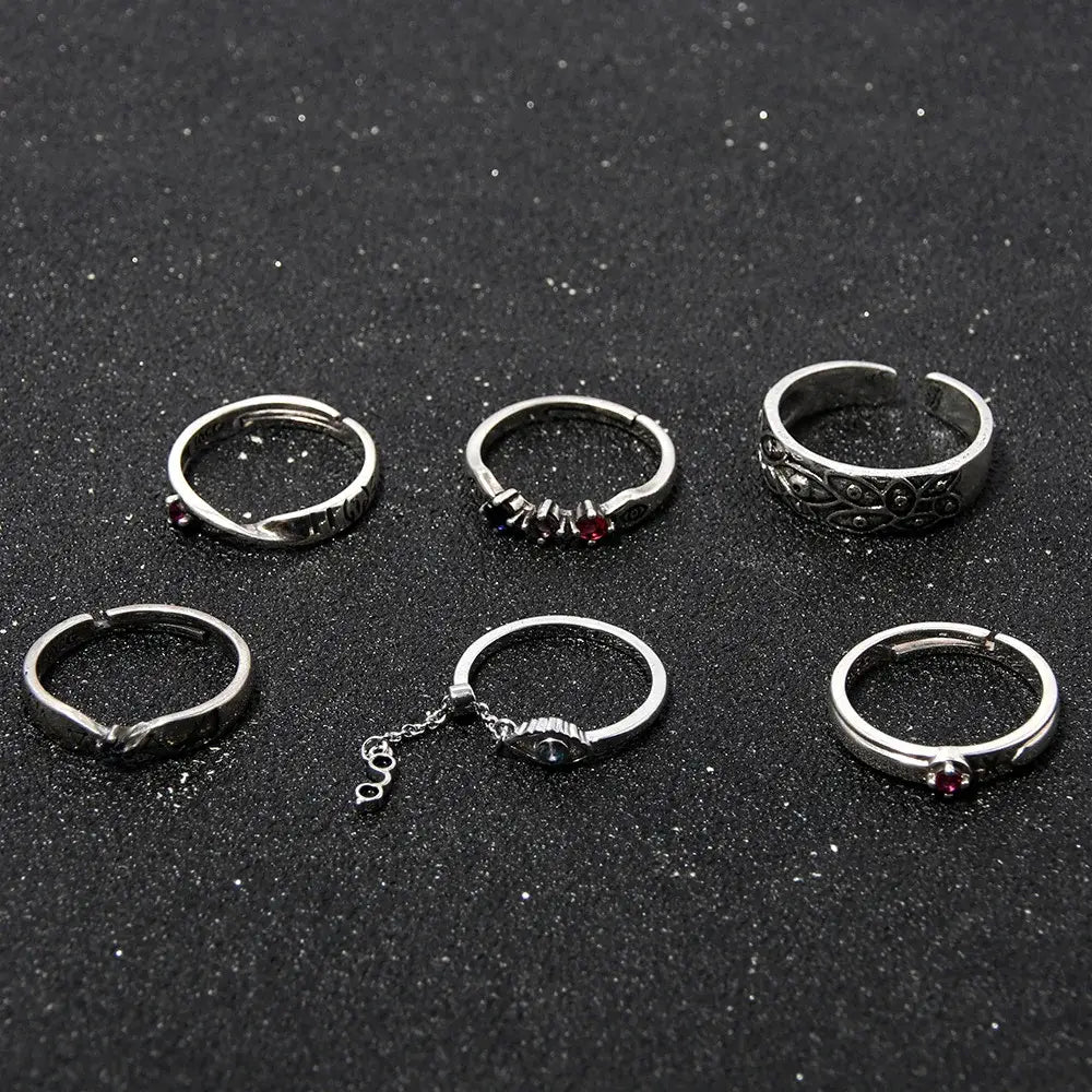Set of six silver-toned jujutsu kaisen yuta okkotsu couple rings with red gemstones and intricate adjustable designs