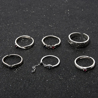 Set of six silver-toned jujutsu kaisen yuta okkotsu couple rings with red gemstones and intricate adjustable designs