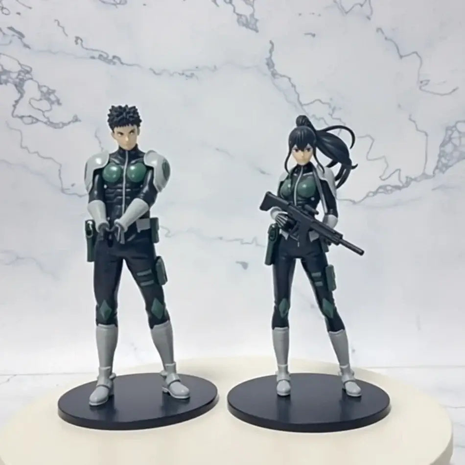Two detailed pvc statue action figures in black and green tactical gear featuring kafka hibino monster form design