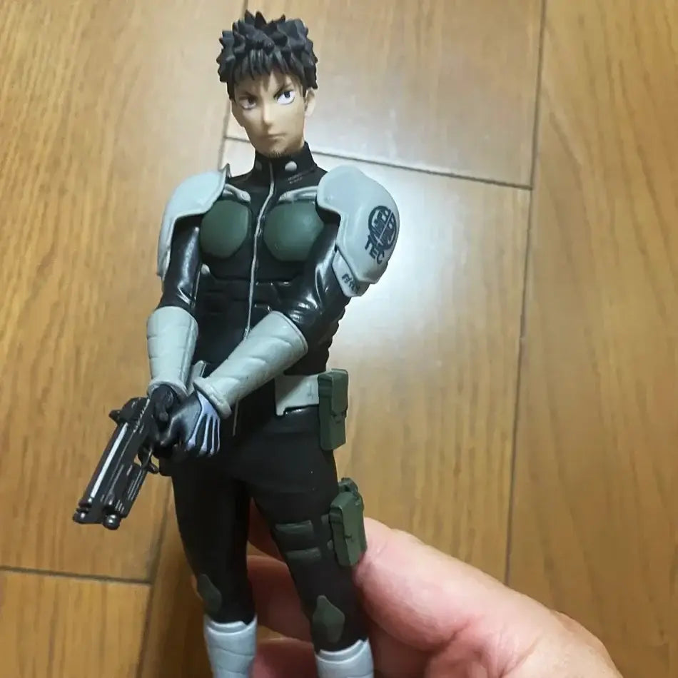 Black and gray armored kaiju no 8 kafka hibino pvc statue with spiky hair holding pistol skeleton design detail