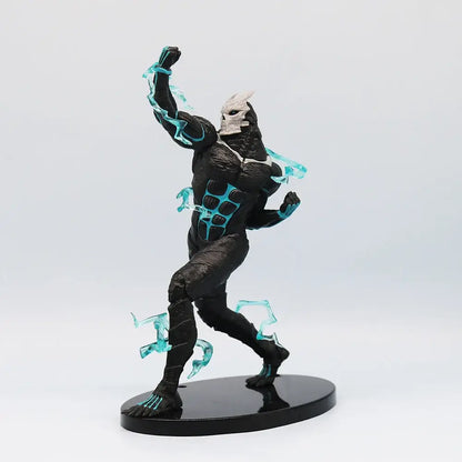 Black and white pvc monster action figure with glowing cyan energy effects standing on a black circular base