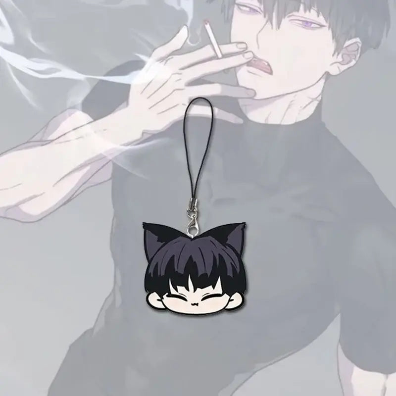 Black cat-eared soshiro hoshina keychain charm with closed eyes and short dark hair on a kawaii phone chain strap