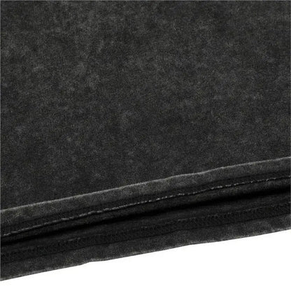 Black denim fabric with faded textured finish and visible stitching on hem of kaiju no 8 washed cotton t shirt for men