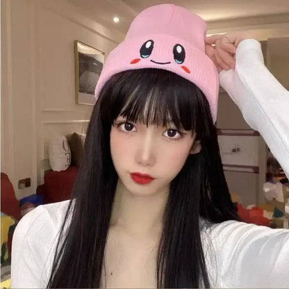 Pink kirby plush hat knit beanie with kawaii face, black eyes, red cheeks, and soft plush material