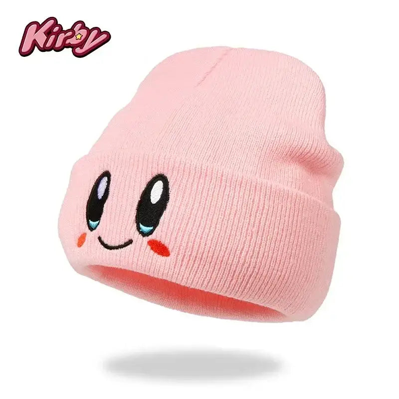 Pink knit kirby plush hat with kawaii embroidered eyes rosy cheeks and smiling mouth inspired by kirby plush design