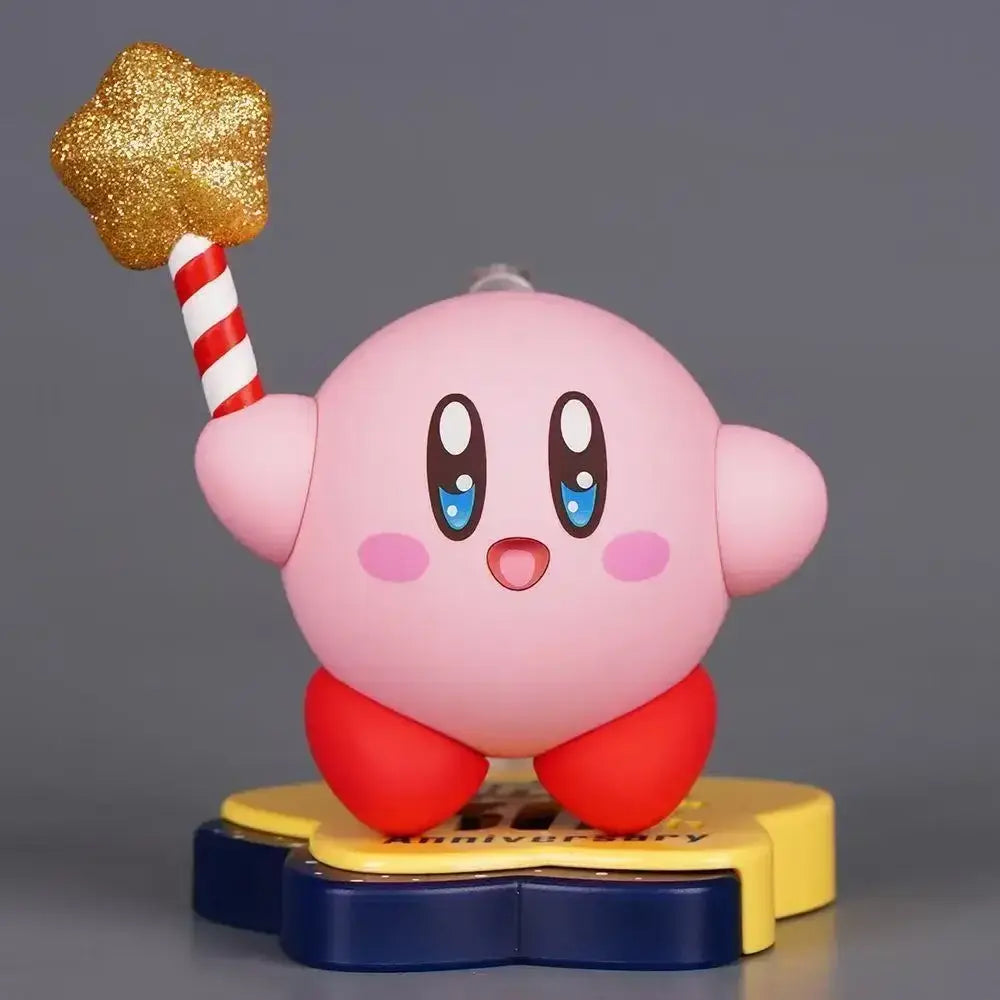 Pink kirby pvc figure 30th anniversary edition holding glittery gold star on red white striped stick on yellow blue base
