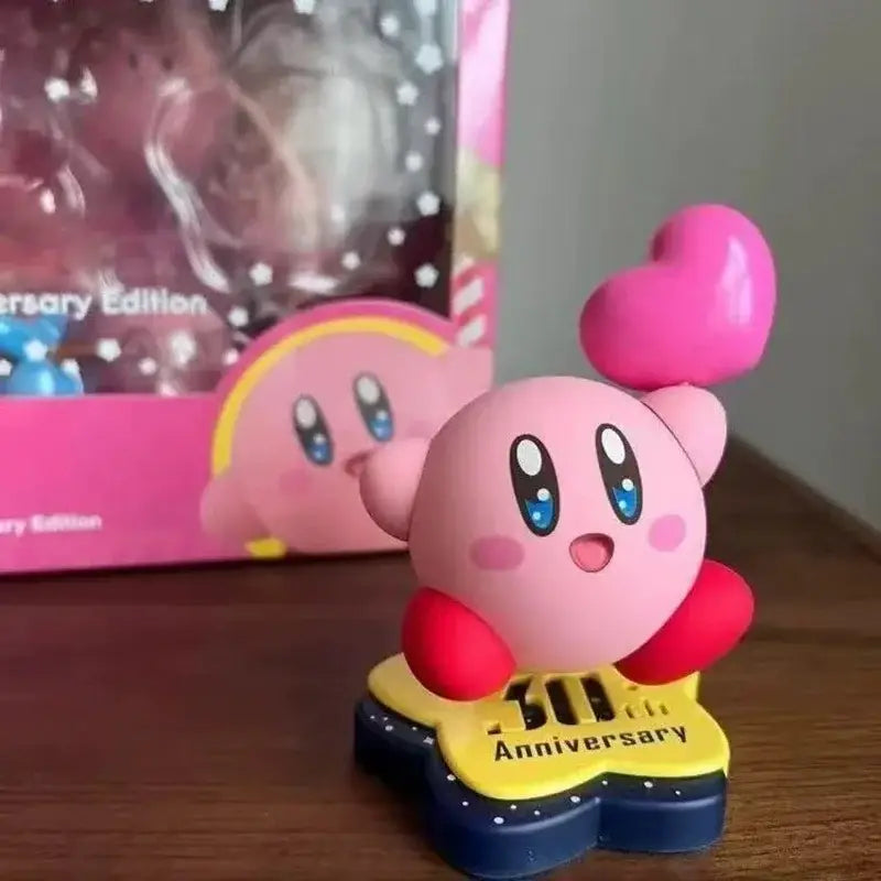Pink kirby pvc figure with red arms and heart accessory on yellow blue star base for 30th anniversary edition