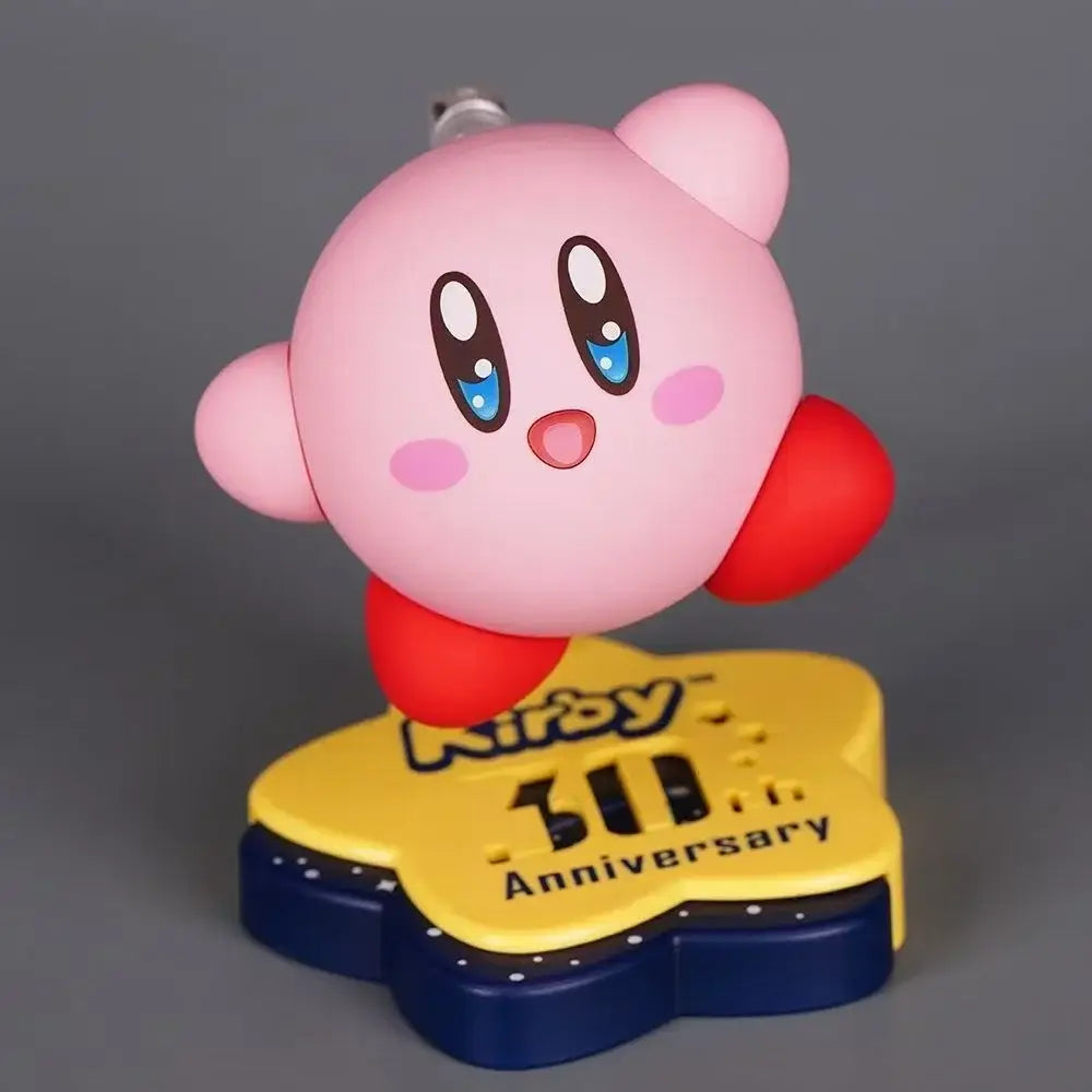 Pink kirby pvc figure with red cheeks on a yellow and blue star base for kirby 30th anniversary edition