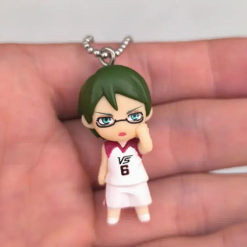 Kuroko’s basketball kise ryota pvc figure keychain features a small green-haired character with glasses in a white maroon jersey