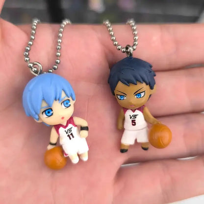 Two chibi style pvc basketball player keychains from kuroko’s basketball featuring kise ryota with blue hair and number 11 jersey