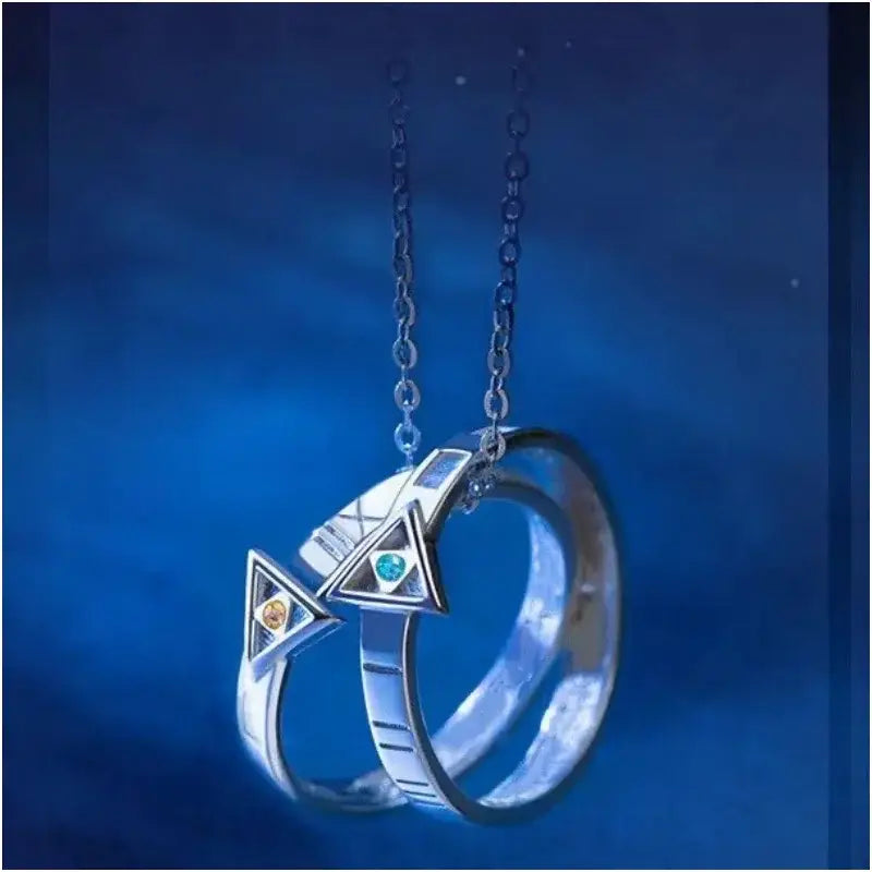 Silver necklace pendant featuring two interlocking rings with triangular cutouts and colorful gemstones cosplay accessory
