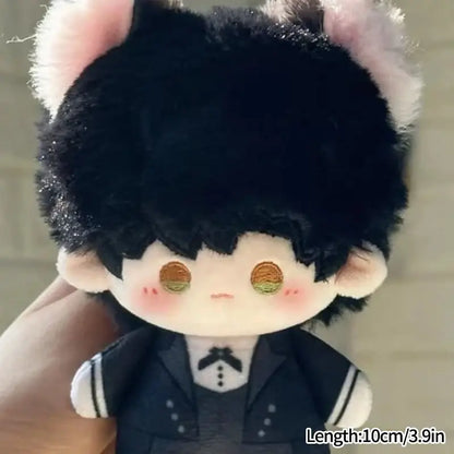 A cute cartoon plush doll keychain with black fluffy hair pink ears and golden eyes wearing a navy blue bag charm