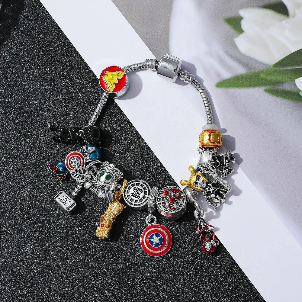 Silver-toned superhero pendant bracelet featuring marvel superhero charms including captain america thor and wonder woman