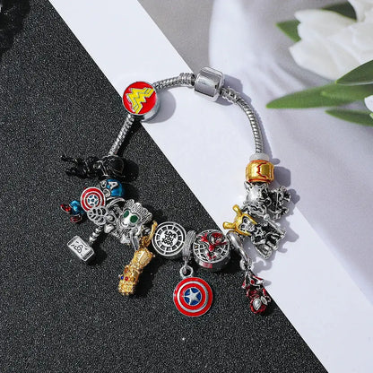 Silver-toned superhero pendant bracelet featuring marvel superhero charms including captain america thor and wonder woman