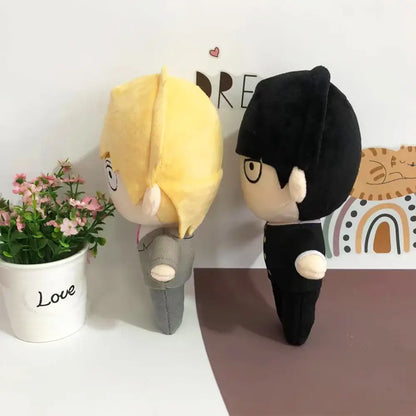 Two soft stuffed plush dolls featuring mob 100 reigen arataka in gray suit with blonde hair and black outfit with black hair