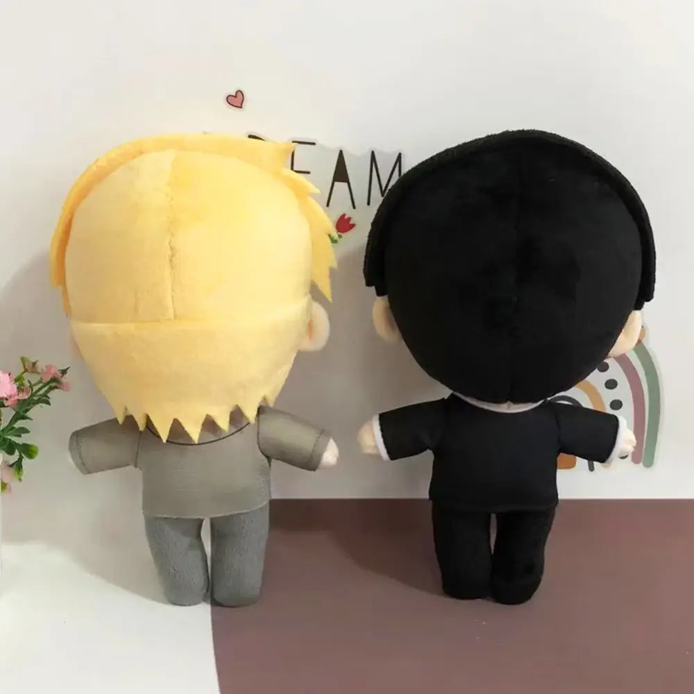 Two soft stuffed plush dolls featuring mob 100 reigen arataka with blonde spiky and black hair in grey and black outfits