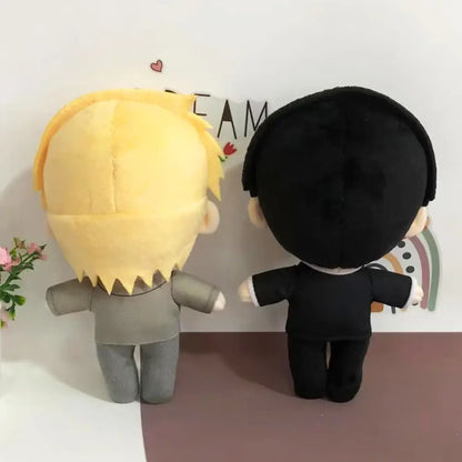 Two soft stuffed plush dolls featuring mob 100 reigen arataka with blonde spiky and black hair in grey and black outfits