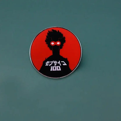 Circular metal brooch featuring kageyama shigeo enamel pin with black silhouette and red background from mob psycho 100