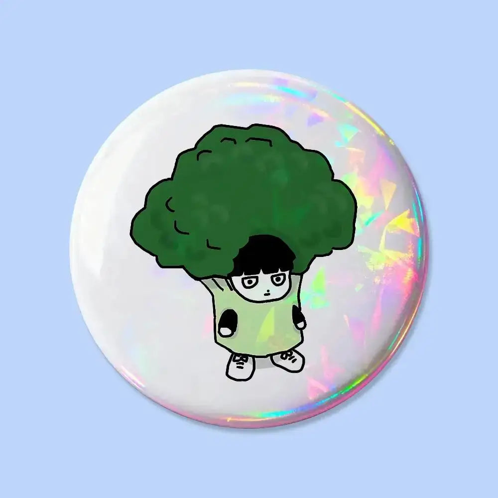 Round iridescent mob psycho pin badge featuring a cartoon character with black hair and green broccoli head