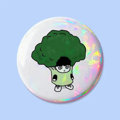 Round iridescent mob psycho pin badge featuring a cartoon character with black hair and green broccoli head
