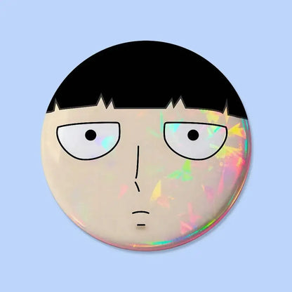 Mob psycho 100 pin badge featuring a round button with a cartoon face, black hair, white eyes, and holographic finish