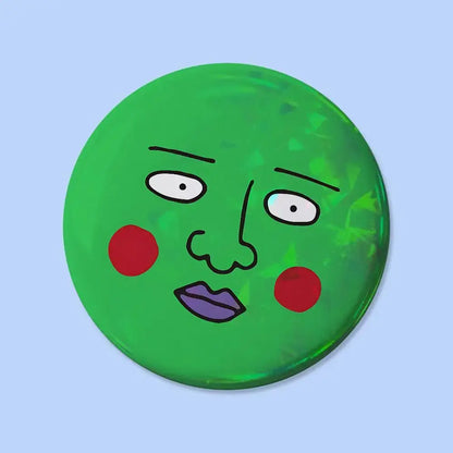 Green circular mob psycho pin badge with cartoon face featuring red cheeks purple lips and black outlined features