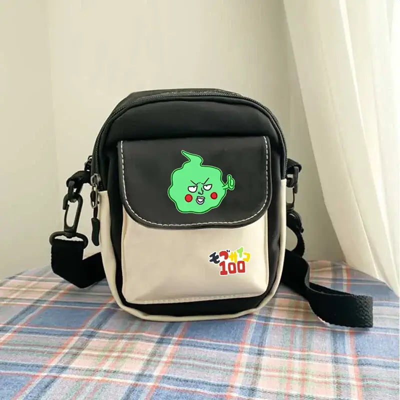 Black and beige crossbody bag featuring a green cartoon character on the flap in mob psycho 100 reigen arataka canvas design