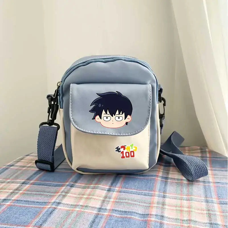 Light blue and cream reigen arataka canvas crossbody bag with mob psycho 100 cartoon face on front flap