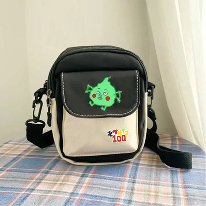 Black and cream reigen arataka canvas crossbody bag featuring green cartoon character with red cheeks on front flap