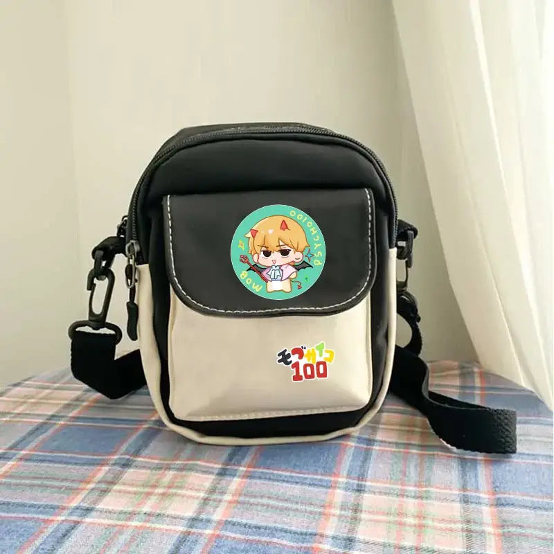 Black and cream arataka canvas crossbody bag with large capacity featuring a circular mob psycho 100 patch and colorful text