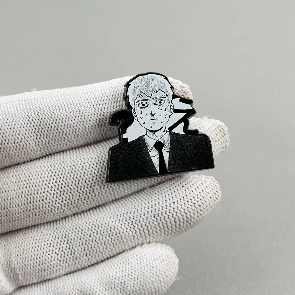 Black and silver enamel mob psycho reigen arataka lapel pin featuring a stylized anime character in a suit and tie