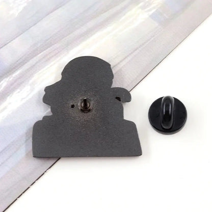 Black enamel mob psycho lapel pin featuring reigen arataka silhouette in official collectible badge style