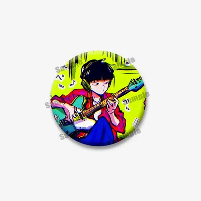 Circular mob psycho lapel pin featuring shigeo arataka with black hair and headphones playing guitar on lime green background