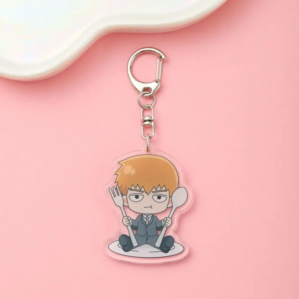 Clear acrylic shigeo kageyama acrylic keychain with orange hair chibi character holding fork and spoon from mob psycho