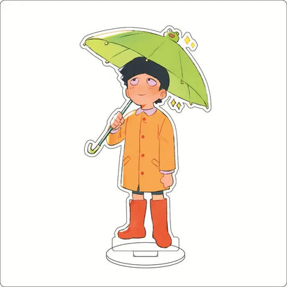 A charming mob psycho shigeo kageyama acrylic stand with a cartoon boy in orange coat holding umbrella acrylic ornament