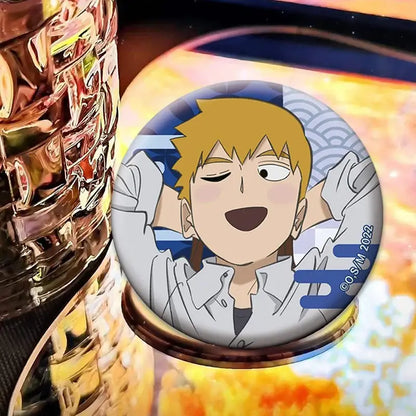 Mob psycho 100 shigeo kageyama button pin featuring a smiling blonde boy on a blue and gray patterned round badge