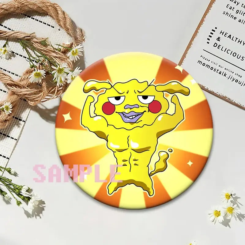 Round glossy yellow and orange mob psycho shigeo kageyama button pin with cartoon character flexing muscles on sunburst background