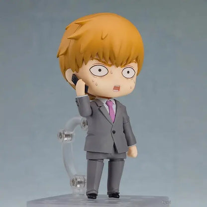 Chibi-style mob psycho shigeo kageyama figure in gray suit with posable faces holding black phone to ear