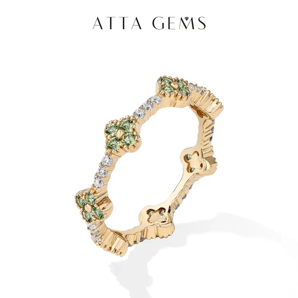 Gold-plated 925 sterling silver moissanite eternity ring with floral design, green gemstones, and clear diamonds