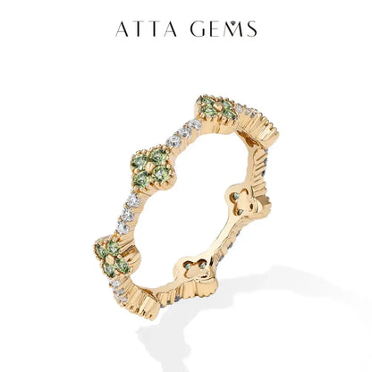Gold-plated 925 sterling silver moissanite eternity ring with floral design, green gemstones, and clear diamonds