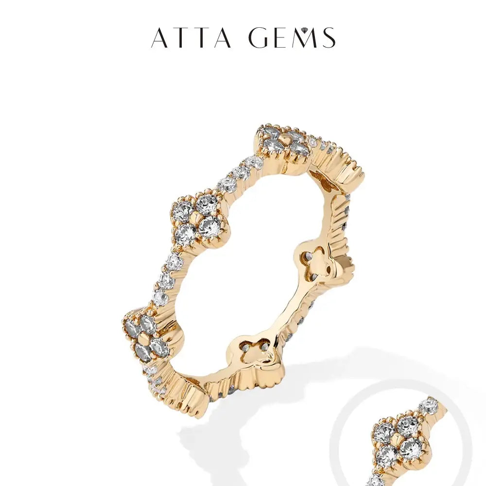 Gold-toned moissanite eternity ring with flower design and clear cubic zirconia on sterling silver band