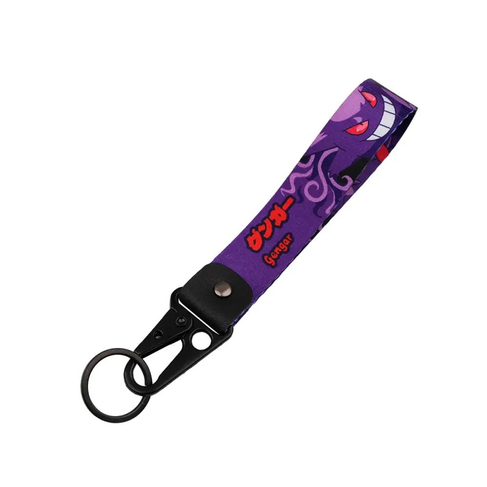 Purple fabric monster original keychain featuring a smiling gengar anime monster with red eyes and kanji text car key accessory