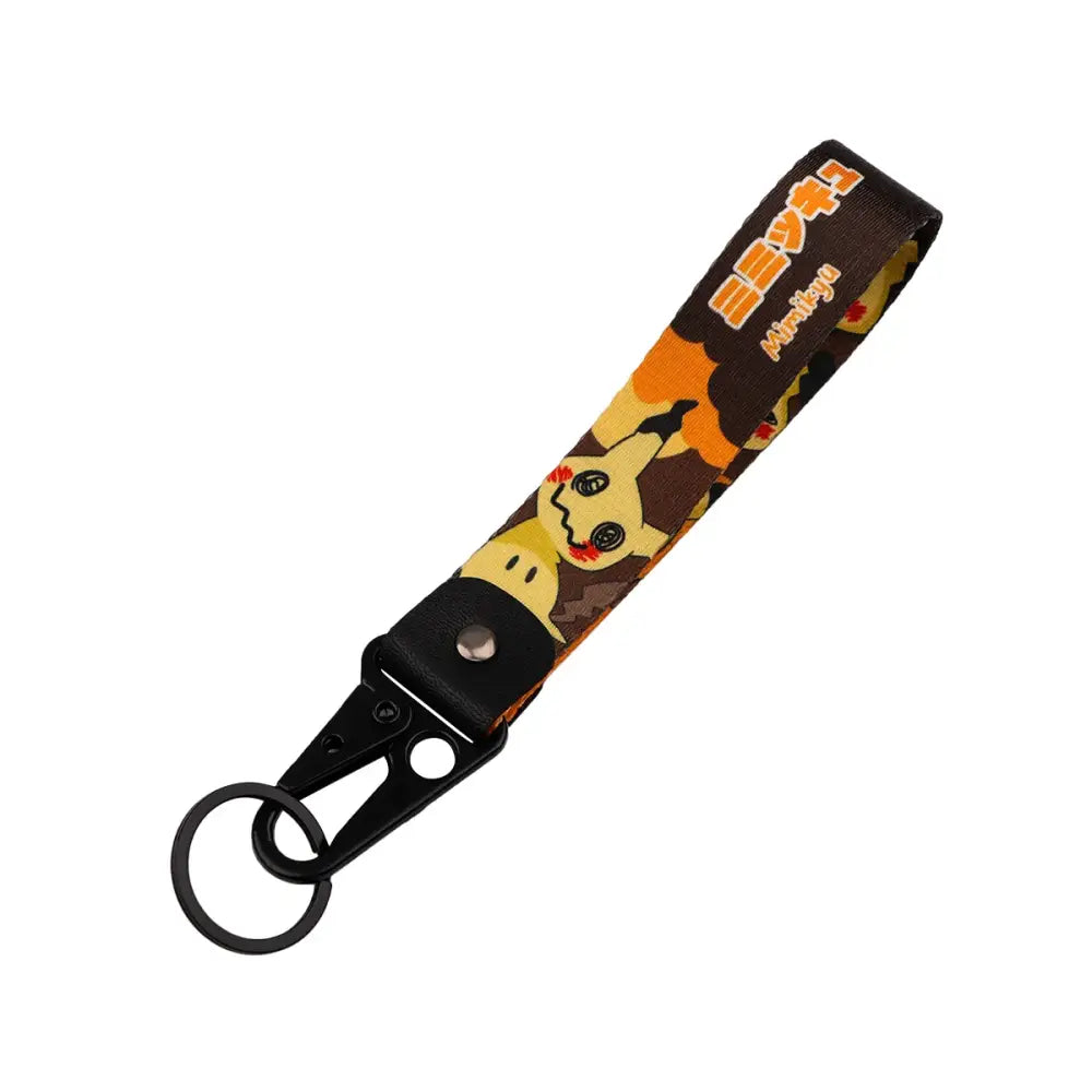 Monster original keychain featuring an anime monster mimikyu in yellow on black and orange camouflage for car keys