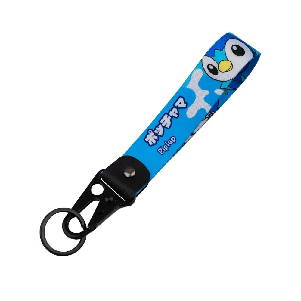 Blue fabric monster original keychain featuring cartoon piplup with white splashes and black text on a black carabiner