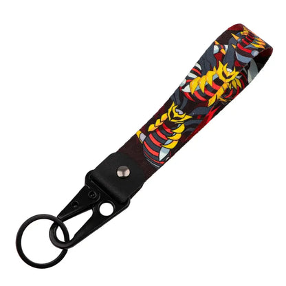 Black fabric monster original keychain with vibrant yellow and red armored anime monster graphic for car key accessory