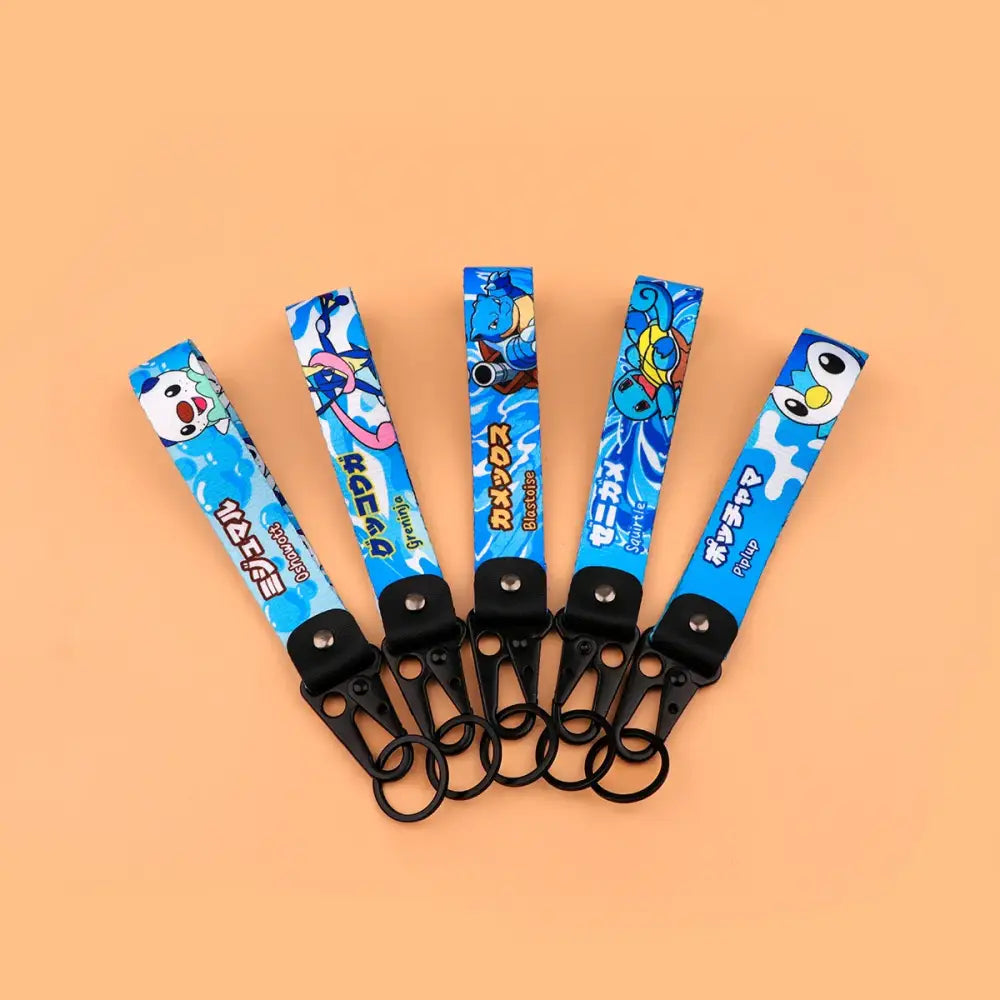 Blue fabric monster original keychain featuring colorful anime monster designs and japanese text with black metal clip