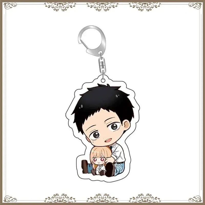 Chibi-style acrylic bag tag featuring kitagawa marin and another anime character with black and blonde hair attached to a silver clip