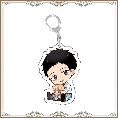 Chibi-style acrylic bag tag featuring kitagawa marin and another anime character with black and blonde hair attached to a silver clip