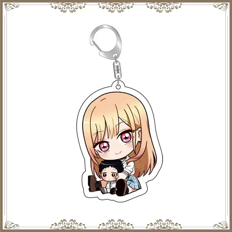 Chibi style acrylic bag tag featuring blonde kitagawa marin with pink eyes holding a smaller boy in school uniforms