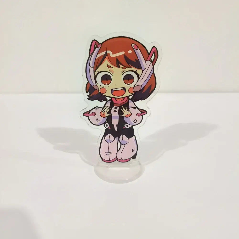 A transparent acrylic figure stand featuring a chibi hero academia character with orange hair and pink white armor